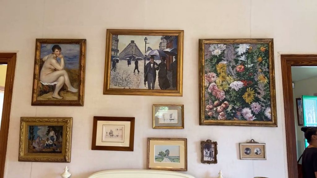 replicas of art works hanging over Claude Monet's bed