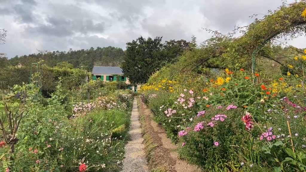 flowers, archway, and Monet's house in background