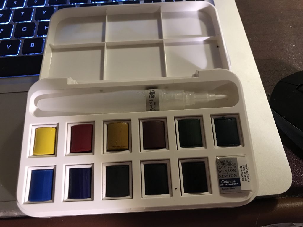 watercolors, brush, and mixing area